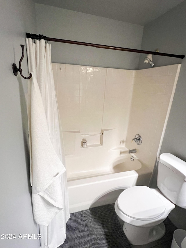 bathroom featuring shower / bath combo with shower curtain and toilet