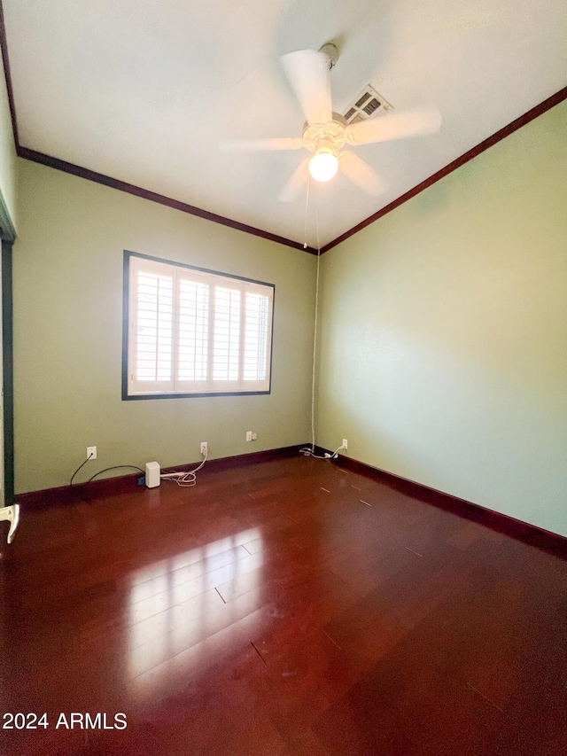 carpeted spare room featuring ceiling fan and crown molding