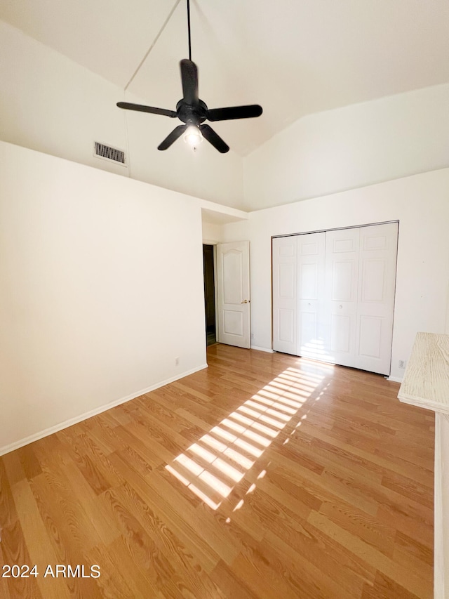 interior space featuring ceiling fan, a closet, lofted ceiling, and light hardwood / wood-style flooring