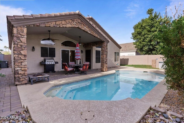 view of swimming pool featuring a patio area, ceiling fan, a grill, and central AC unit