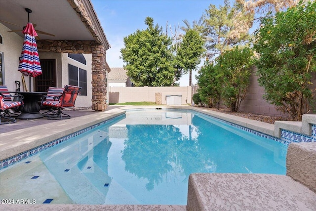 view of swimming pool with ceiling fan