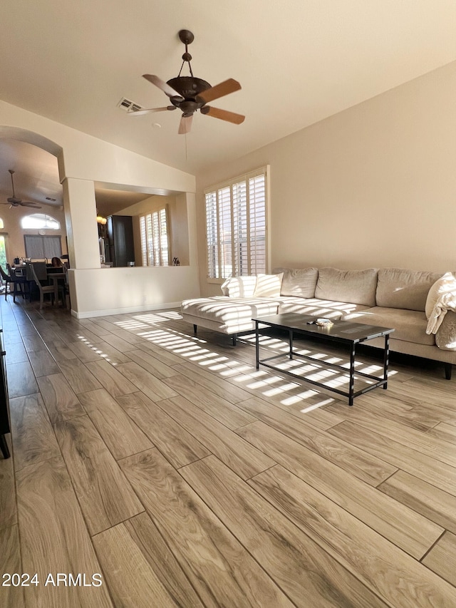 unfurnished living room with ceiling fan and light hardwood / wood-style flooring