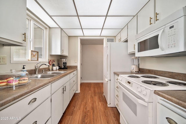 kitchen featuring sink, white appliances, white cabinets, and light wood-type flooring