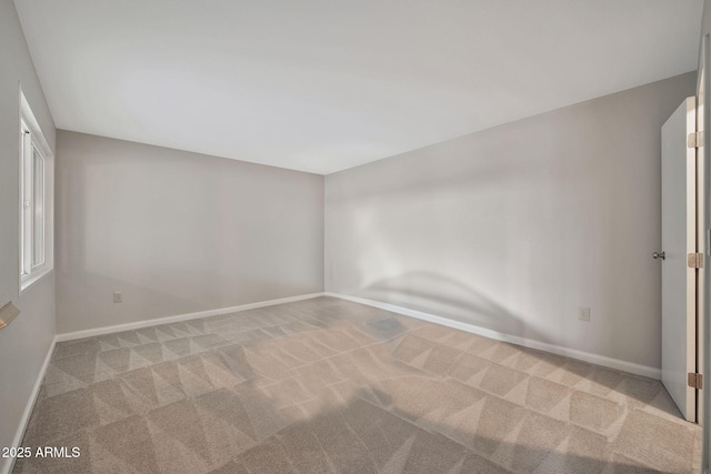 spare room featuring light colored carpet