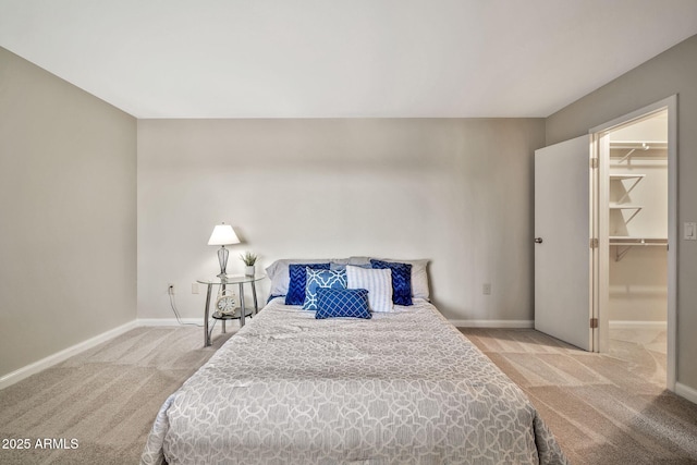 carpeted bedroom with a spacious closet