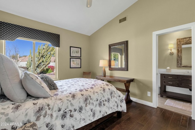 bedroom featuring dark hardwood / wood-style floors, lofted ceiling, and connected bathroom