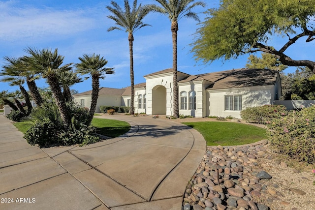 mediterranean / spanish home featuring a front yard