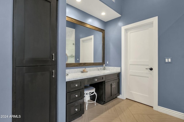 bathroom with vanity and parquet flooring