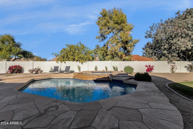 view of pool with an in ground hot tub and a patio