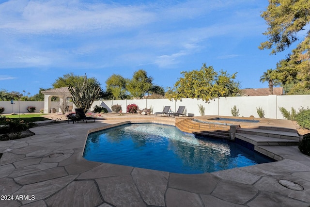 view of swimming pool featuring an in ground hot tub and a patio