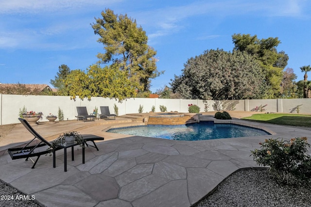 view of swimming pool featuring an in ground hot tub and a patio area