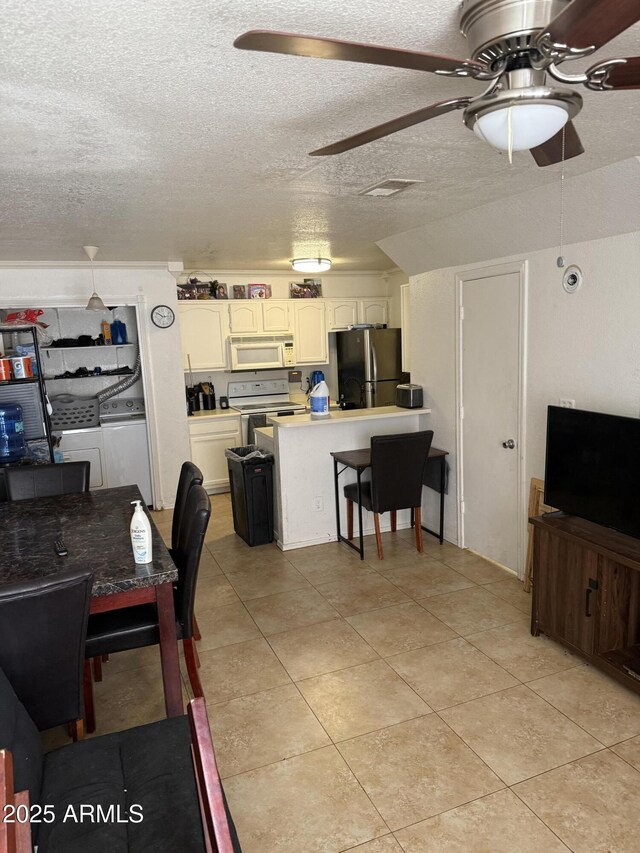 2301 E University Dr Unit 111, Mesa, AZ 85213 - living area featuring ceiling fan, independent washer and dryer, a textured ceiling, and light tile patterned floors