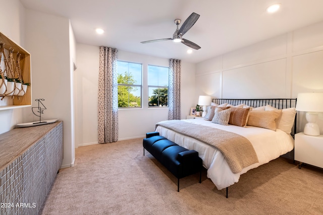 bedroom featuring ceiling fan and light carpet