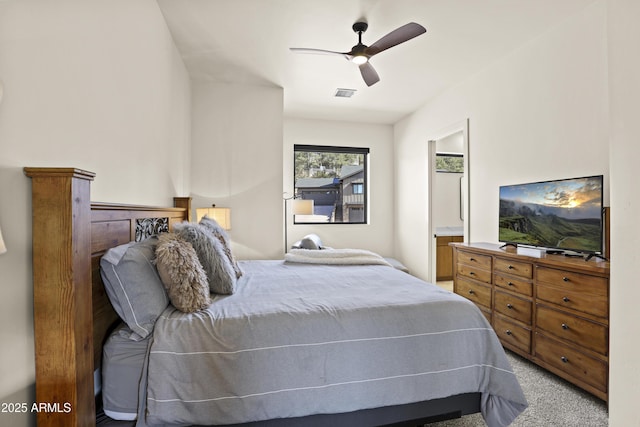 carpeted bedroom with visible vents and a ceiling fan