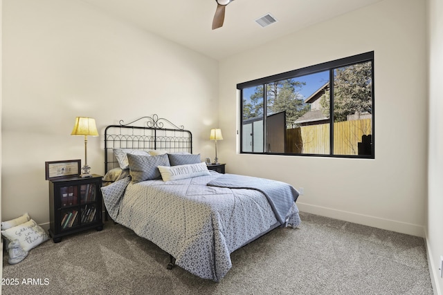 carpeted bedroom with a ceiling fan, visible vents, and baseboards