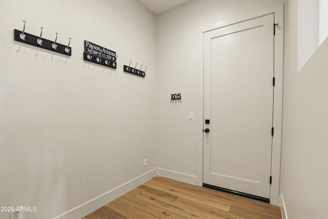 doorway featuring light wood-type flooring and baseboards