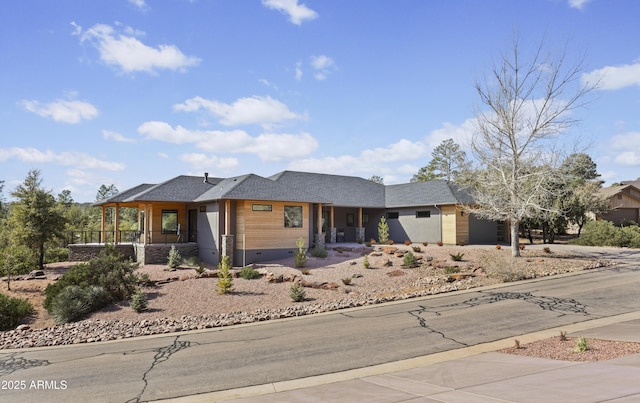 view of front of house featuring a garage, concrete driveway, a porch, and crawl space