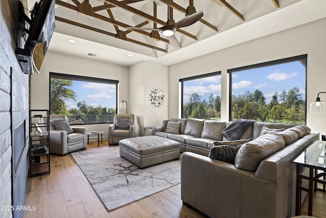 living room featuring a ceiling fan, visible vents, wood finished floors, and recessed lighting