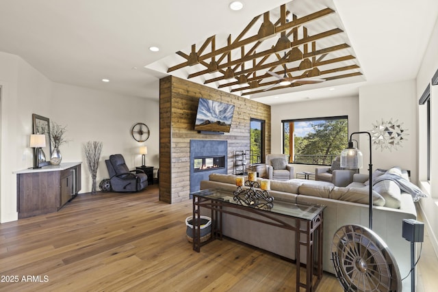 living area featuring a fireplace, wood finished floors, and recessed lighting