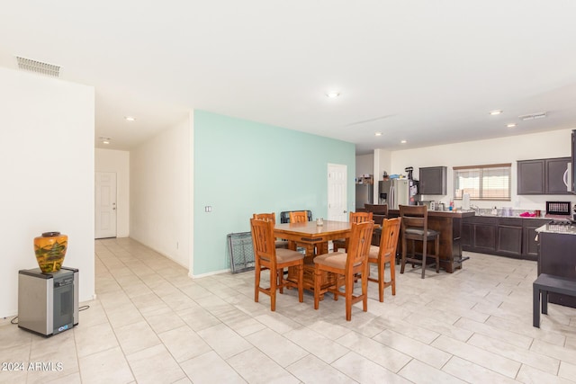 dining space with light tile patterned floors, visible vents, and recessed lighting