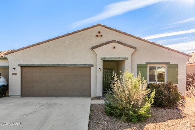 mediterranean / spanish home with driveway, an attached garage, and stucco siding