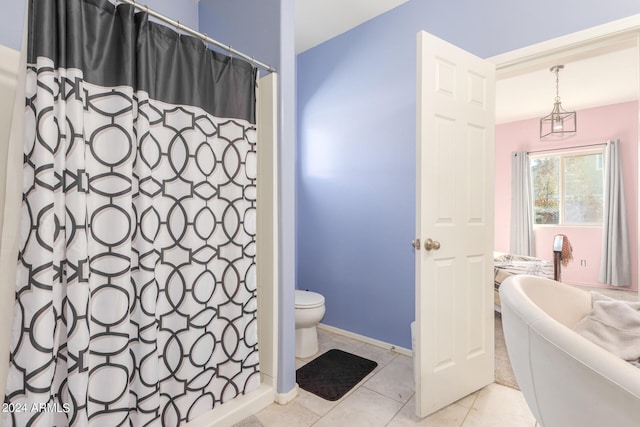 bathroom with baseboards, a shower with shower curtain, toilet, and tile patterned floors