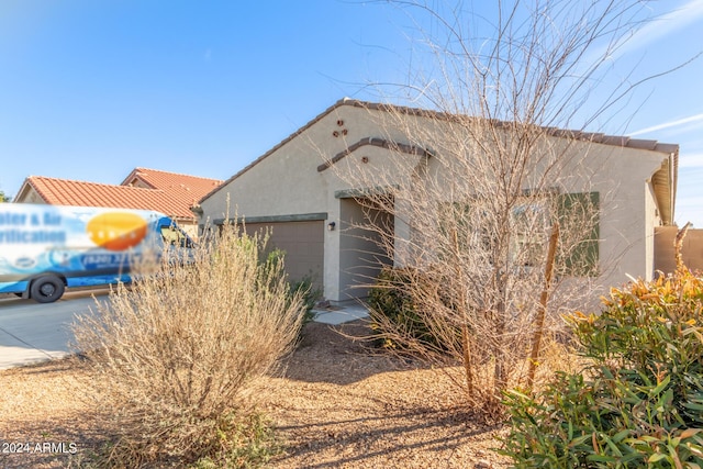 view of home's exterior featuring a garage and stucco siding