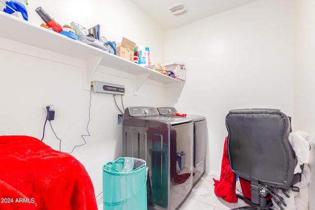 clothes washing area featuring light tile patterned floors, laundry area, independent washer and dryer, and visible vents