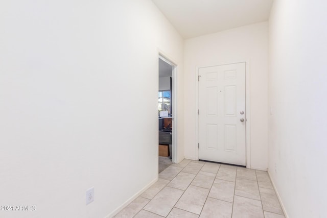 interior space with light tile patterned flooring and baseboards