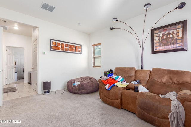 living room with light carpet, light tile patterned floors, and visible vents