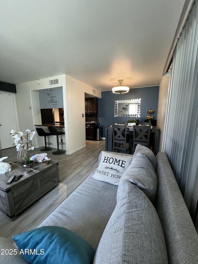 living area with a chandelier and wood finished floors