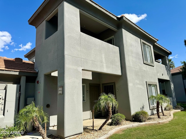 rear view of property with a balcony