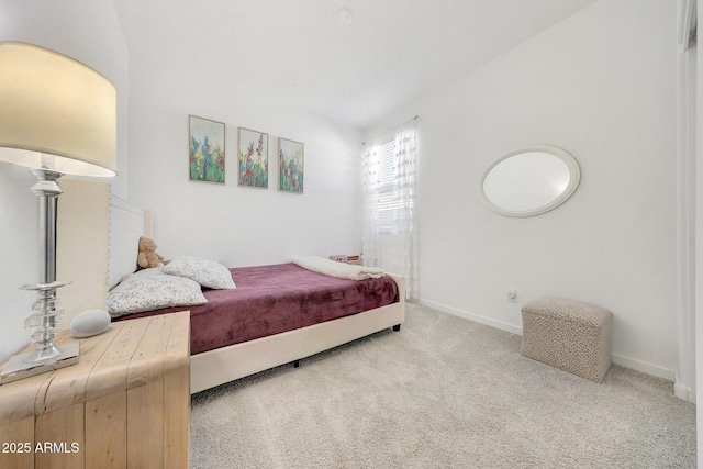 carpeted bedroom featuring vaulted ceiling