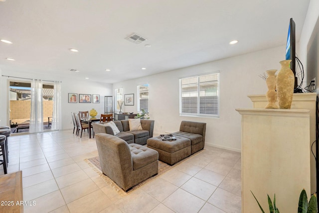 living room with light tile patterned floors and a wealth of natural light