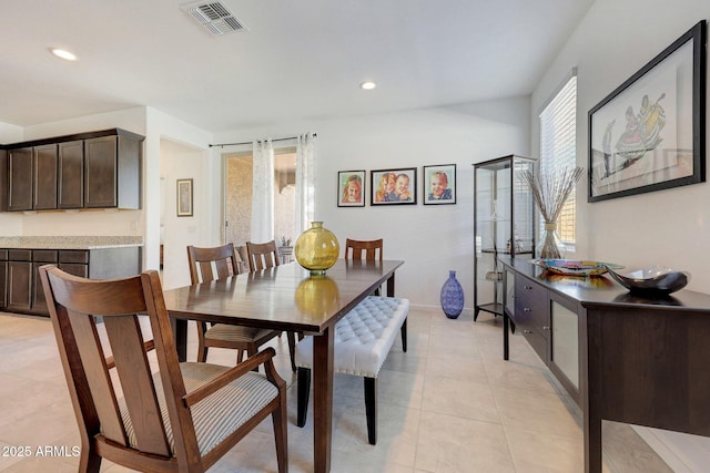 dining space featuring light tile patterned flooring