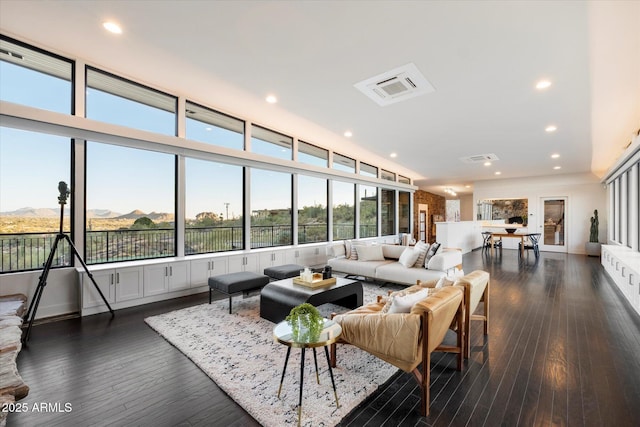 living room with recessed lighting, visible vents, and dark wood finished floors