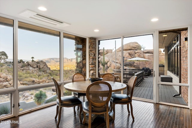 sunroom featuring visible vents and a mountain view