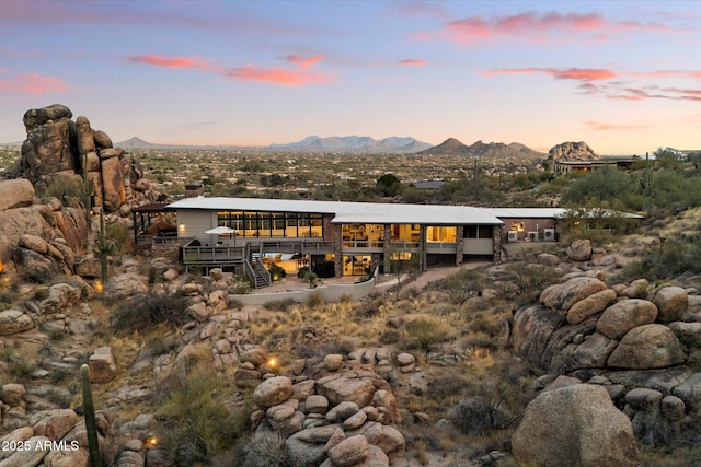 rear view of property featuring a mountain view