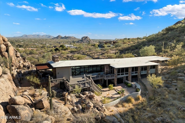 rear view of property with a mountain view