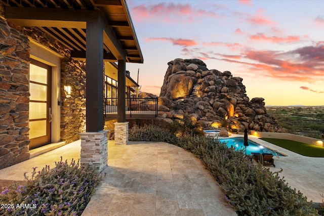 view of patio terrace at dusk