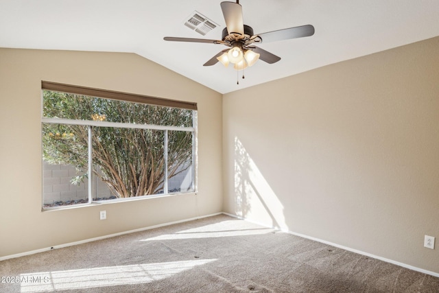 carpeted empty room with ceiling fan and vaulted ceiling