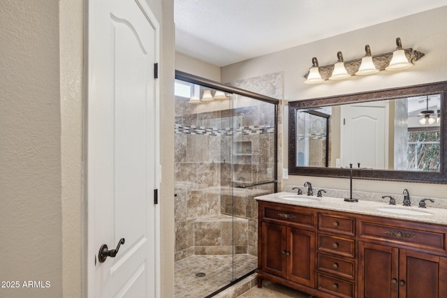 bathroom featuring vanity and a shower with shower door