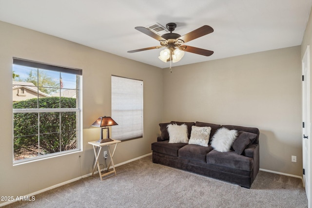 carpeted living room featuring ceiling fan