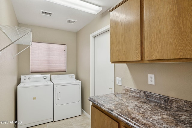 washroom with cabinets and washer and dryer