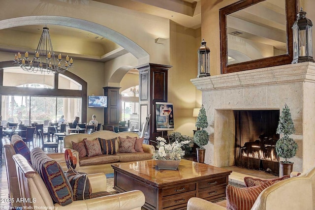 living room featuring an inviting chandelier and a towering ceiling