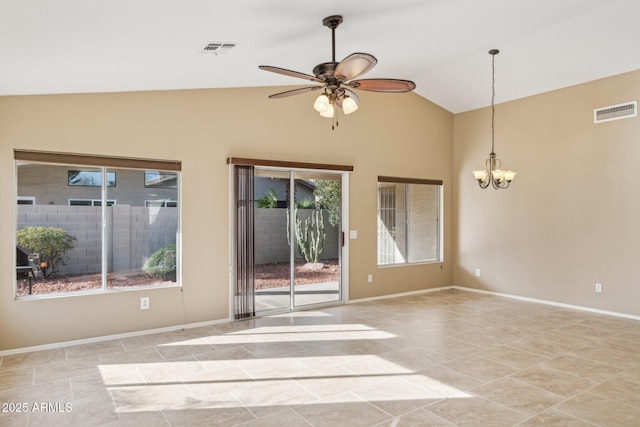 tiled empty room featuring lofted ceiling and ceiling fan with notable chandelier