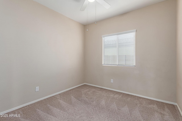 carpeted spare room featuring ceiling fan