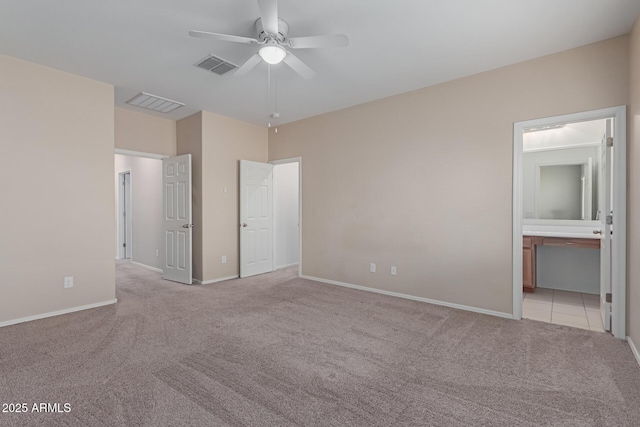 unfurnished bedroom with light carpet, ceiling fan, and ensuite bathroom