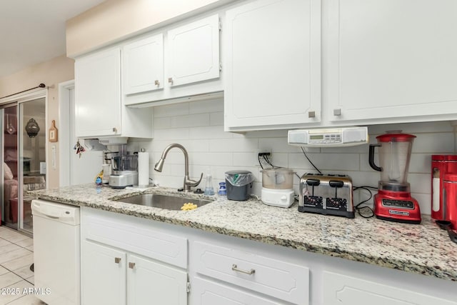 kitchen with dishwasher, sink, decorative backsplash, and white cabinets