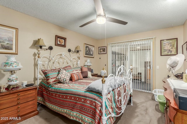 carpeted bedroom with ceiling fan, access to exterior, and a textured ceiling